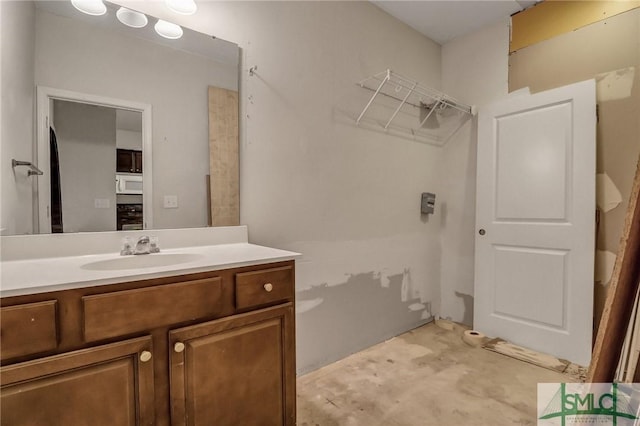 bathroom with unfinished concrete flooring and vanity