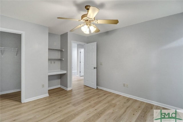 unfurnished bedroom with ceiling fan, a closet, wood finished floors, and baseboards