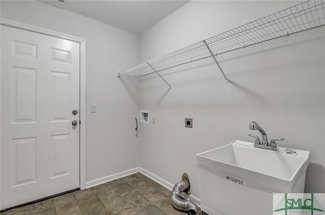 washroom featuring laundry area, baseboards, hookup for an electric dryer, washer hookup, and a sink