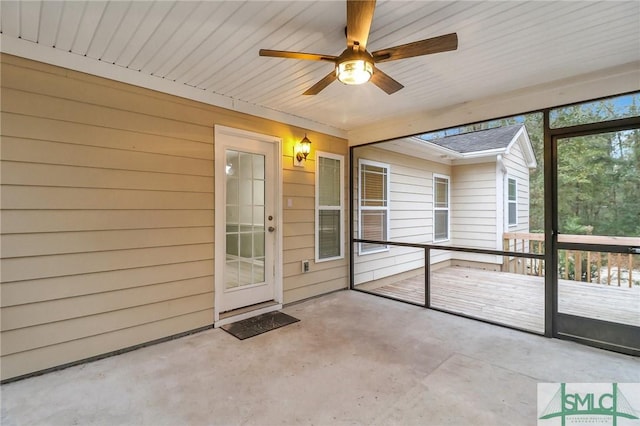 unfurnished sunroom with a ceiling fan