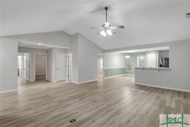 unfurnished living room with visible vents, light wood-style floors, vaulted ceiling, ceiling fan, and baseboards