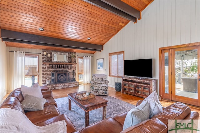 living room with wooden ceiling, a fireplace, lofted ceiling with beams, and wood finished floors