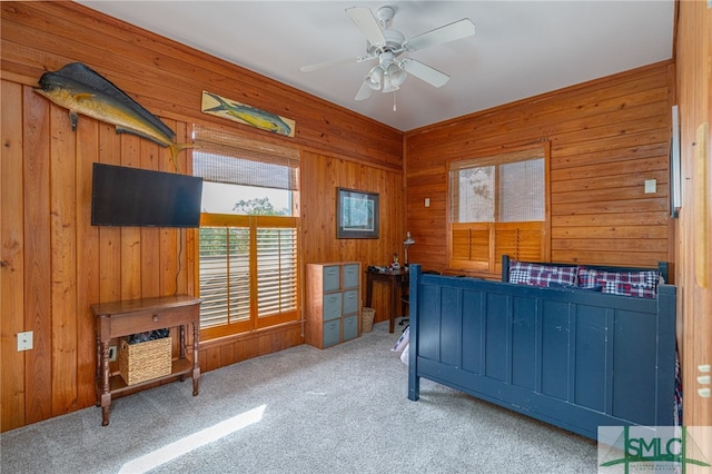 carpeted bedroom with wood walls