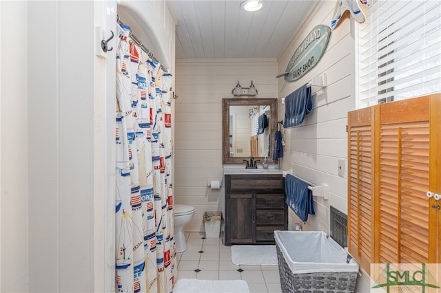 bathroom featuring a shower with shower curtain, vanity, toilet, and tile patterned floors