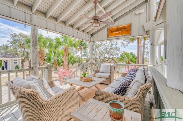 sunroom / solarium featuring ceiling fan and lofted ceiling with beams