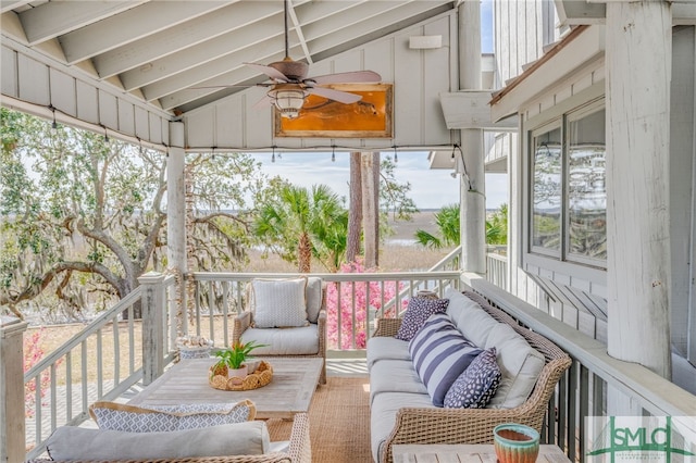 sunroom / solarium featuring vaulted ceiling with beams and ceiling fan