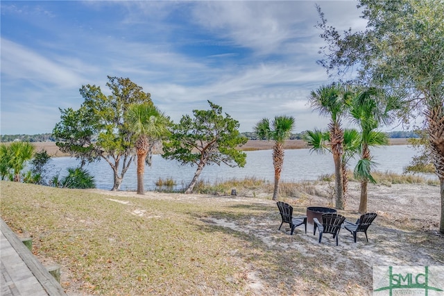 view of yard featuring an outdoor fire pit and a water view