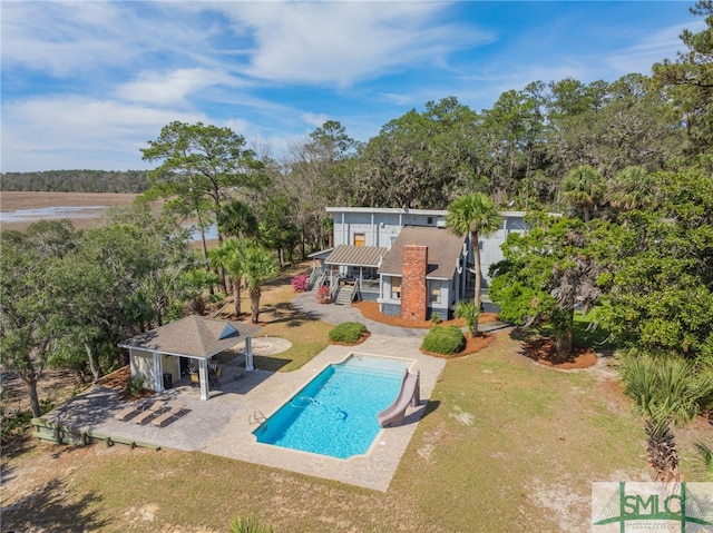 outdoor pool featuring a yard, a patio, and a gazebo