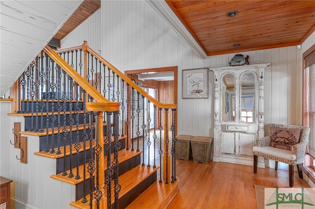 stairway with wooden ceiling and wood finished floors