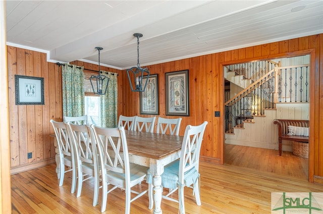 dining area with stairway, baseboards, and wood finished floors