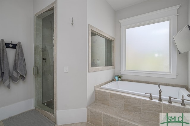 bathroom with a shower stall and a bath