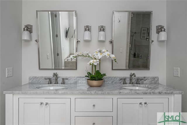 bathroom featuring double vanity, a shower, and a sink