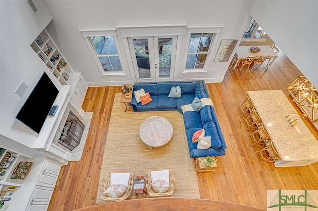 living room with baseboards, wood finished floors, and french doors