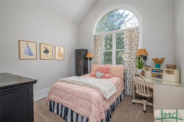 carpeted bedroom featuring lofted ceiling and baseboards