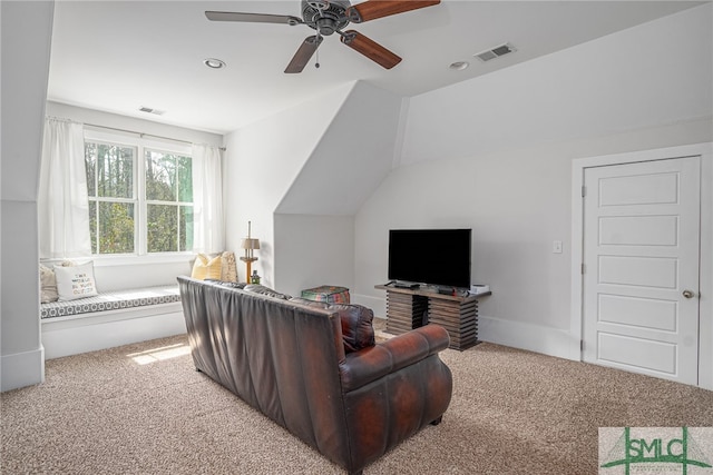 living room featuring ceiling fan, visible vents, vaulted ceiling, and carpet flooring