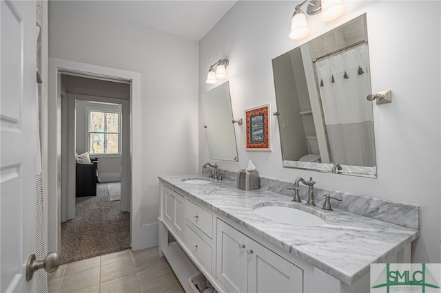 full bathroom with tile patterned flooring, a sink, and double vanity