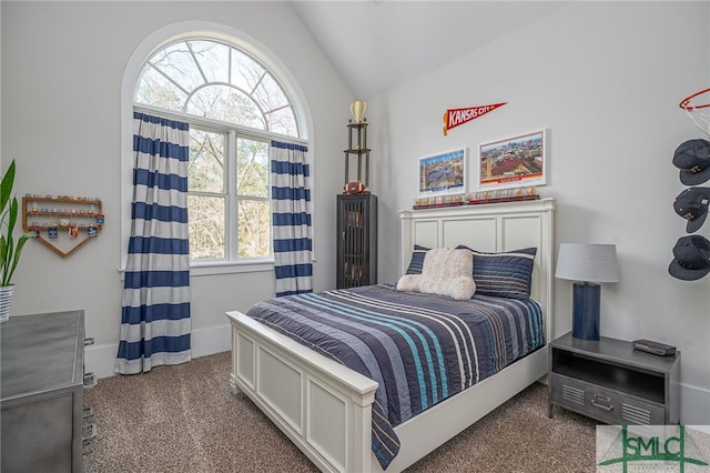 bedroom featuring carpet, baseboards, and vaulted ceiling