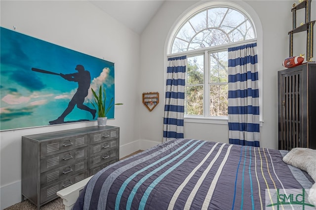 bedroom with vaulted ceiling and baseboards