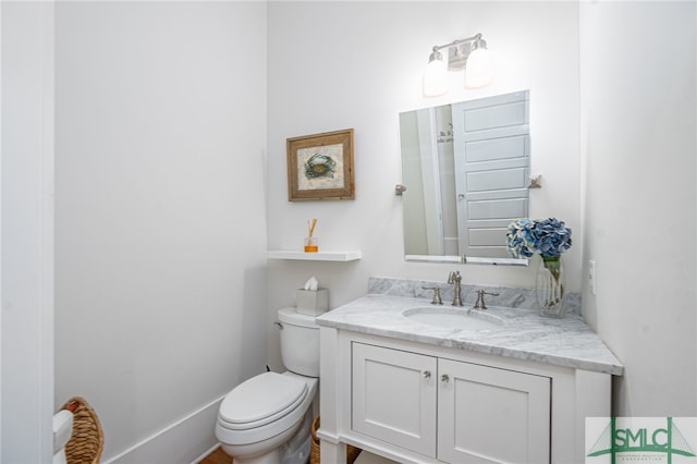 half bathroom with vanity and toilet