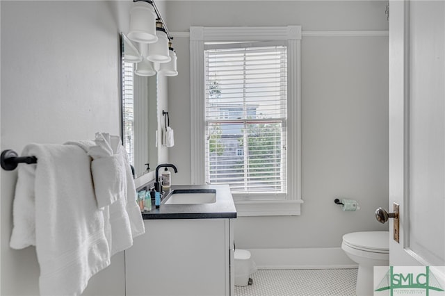 half bath featuring toilet, tile patterned flooring, and vanity