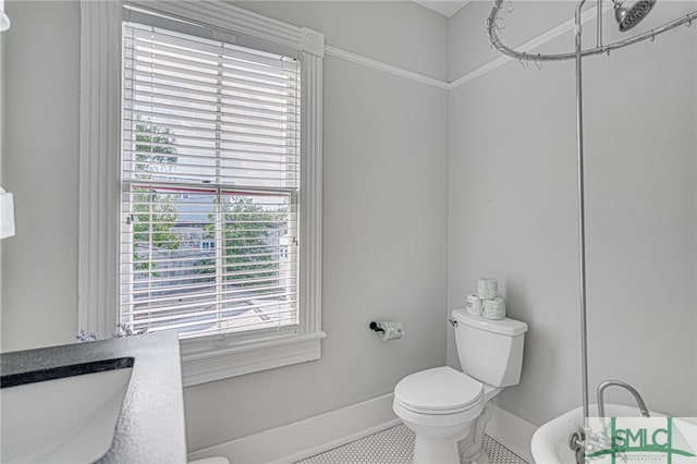 bathroom featuring toilet and baseboards