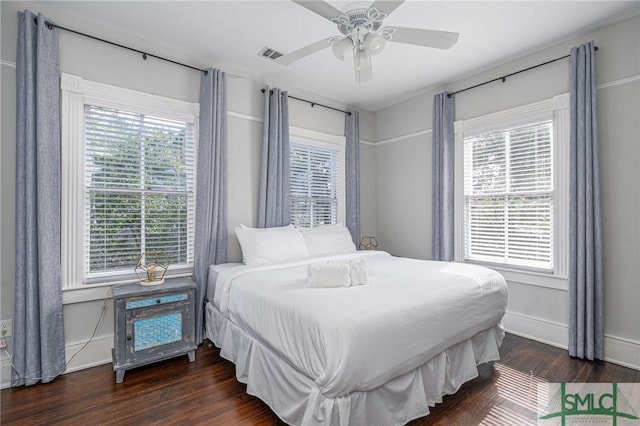 bedroom featuring multiple windows, visible vents, and wood finished floors