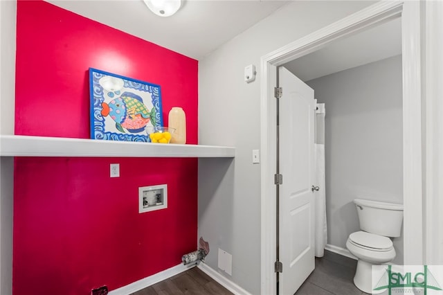 interior space featuring baseboards and toilet