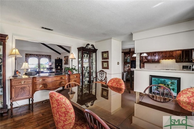 126 Grove Point Island Rd, Savannah, GA 31419 - dining room with a textured ceiling, dark wood finished floors, and crown molding