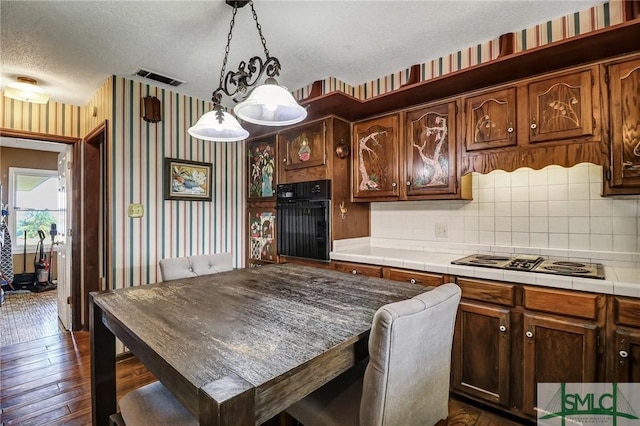 126 Grove Point Island Rd, Savannah, GA 31419 - kitchen featuring wallpapered walls, black oven, a textured ceiling, electric cooktop, and tile countertops