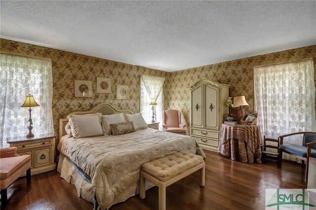 126 Grove Point Island Rd, Savannah, GA 31419 - bedroom with wallpapered walls, a textured ceiling, and dark wood-style floors