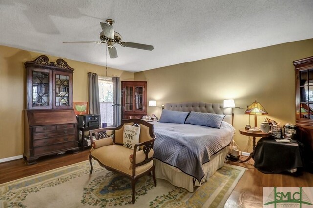 126 Grove Point Island Rd, Savannah, GA 31419 - bedroom with wood finished floors, baseboards, ceiling fan, and a textured ceiling