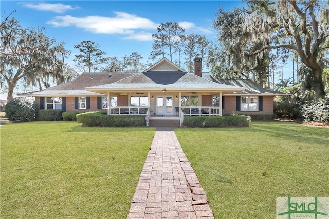 126 Grove Point Island Rd, Savannah, GA 31419 - view of front of home featuring covered porch, brick siding, and a front lawn