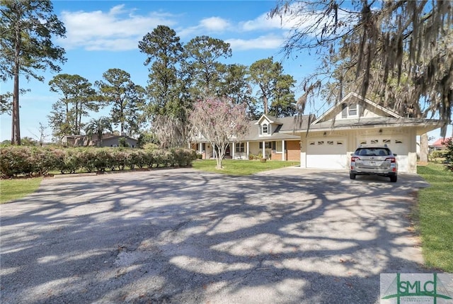 126 Grove Point Island Rd, Savannah, GA 31419 - view of front of home with asphalt driveway, a garage, a front yard, and covered porch