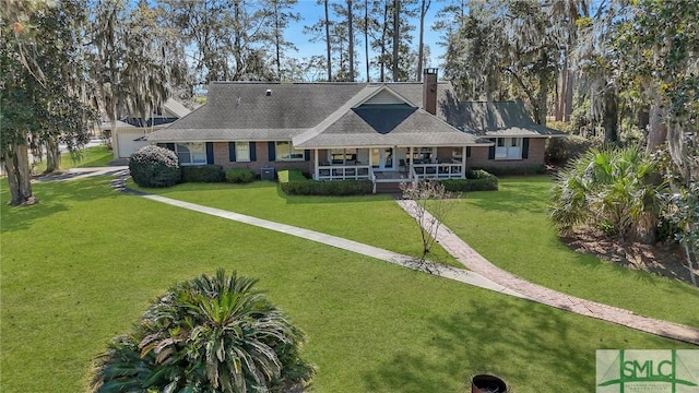 126 Grove Point Island Rd, Savannah, GA 31419 - view of front of house with covered porch, a front yard, a chimney, and brick siding