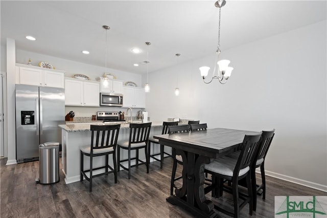 dining room featuring dark wood-style floors, baseboards, and recessed lighting