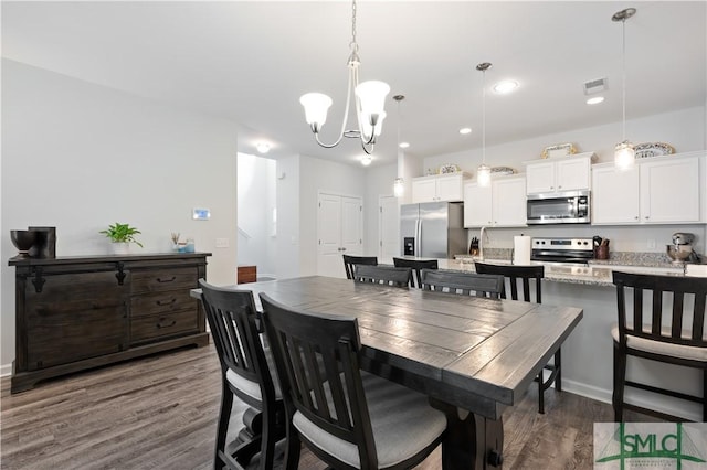 dining area featuring visible vents, dark wood finished floors, a notable chandelier, and recessed lighting