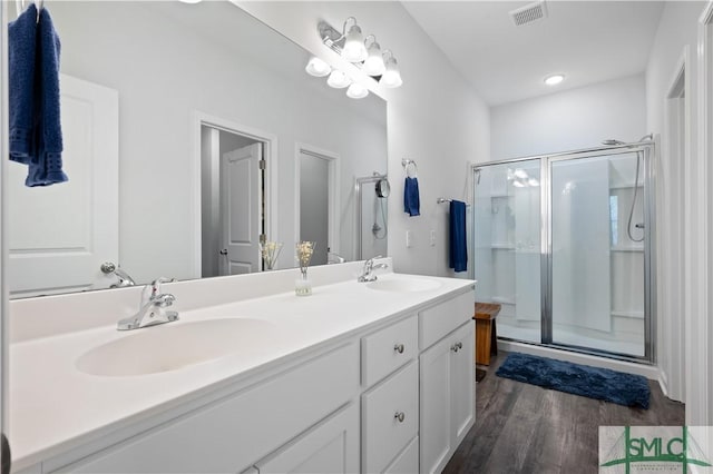 full bath with a shower stall, visible vents, and a sink