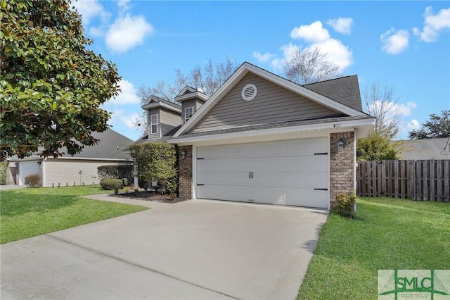 view of front facade with a front yard, concrete driveway, brick siding, and fence