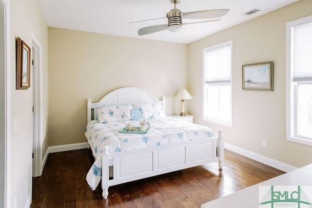 bedroom with visible vents, ceiling fan, baseboards, and wood finished floors