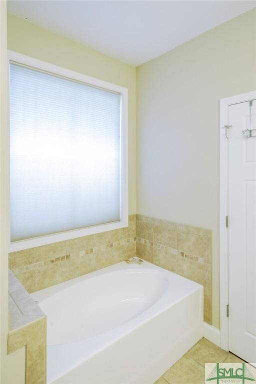 bathroom featuring a garden tub and tile patterned floors