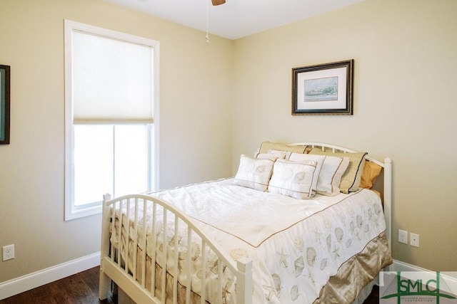 bedroom featuring baseboards and wood finished floors