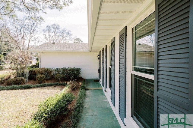 view of side of home featuring a shingled roof