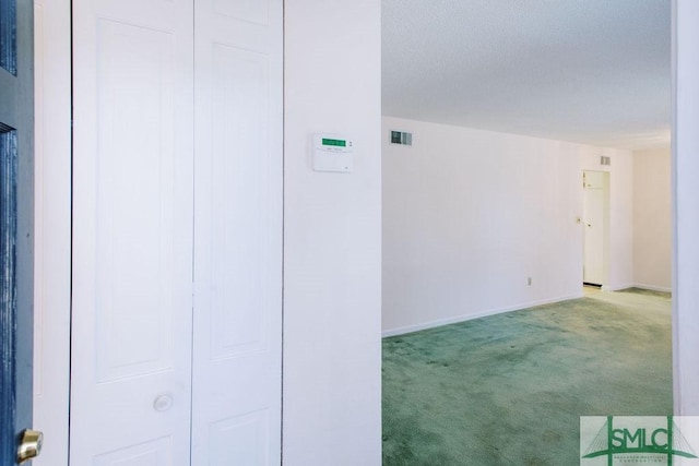 interior space featuring baseboards, visible vents, and a textured ceiling