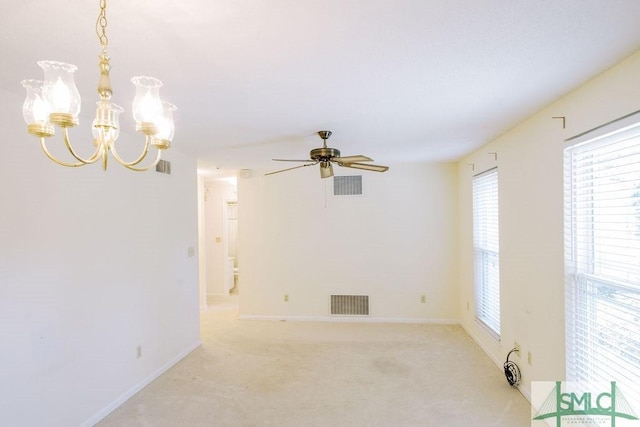 unfurnished room featuring baseboards, visible vents, and light colored carpet