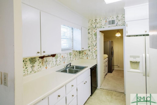 kitchen with wallpapered walls, black dishwasher, white refrigerator with ice dispenser, freestanding refrigerator, and a sink