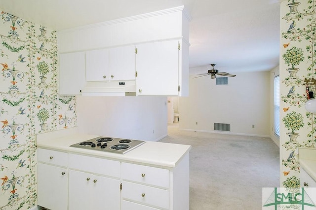 kitchen featuring light countertops, visible vents, stainless steel electric stovetop, under cabinet range hood, and wallpapered walls