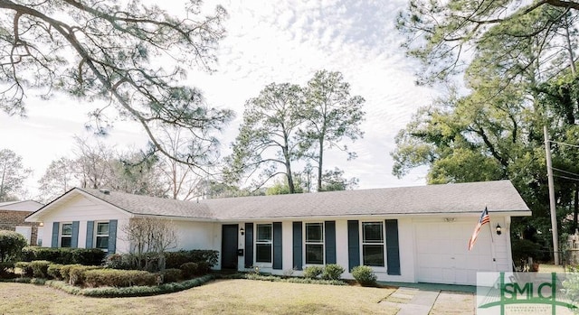 ranch-style house featuring a garage, a front lawn, and concrete driveway