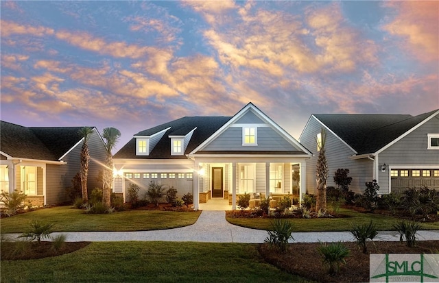 view of front facade featuring covered porch, driveway, and a front lawn