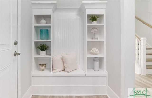 interior space featuring baseboards, wood finished floors, and built in features