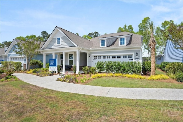 323 Birch Dr, Richmond Hill, GA 31324 - view of front of house featuring a garage, a front yard, and a porch